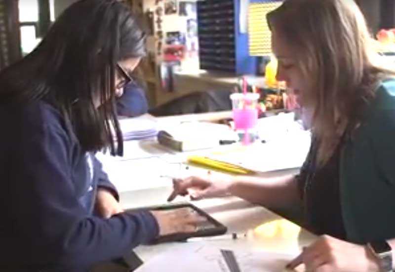 Photo of teacher and student in conference using tablet device