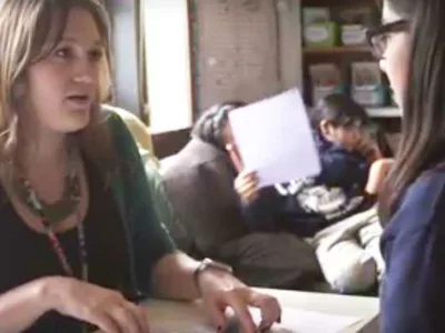 Photo of teacher and student discussing goals
