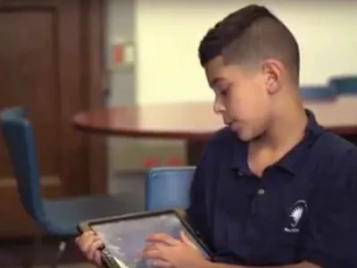 Photo of student explaining tablet presentation
