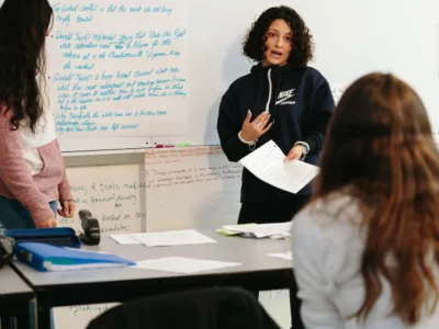 Student speaks in front of class
