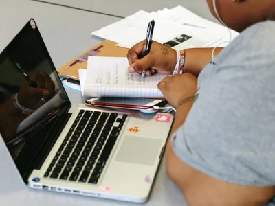 Student writes in notebook
