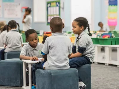 Photo of small group of students seated and working together
