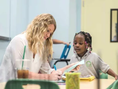Photo of teacher and student working together at a table
