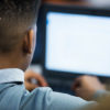 View of back of student's head as he sits, looking at laptop screen